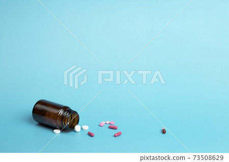 Various medicine. Different colour capsule and pill bottle 73508629