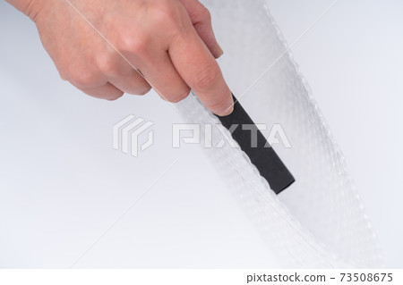 Hands of a woman doing packing work 73508675