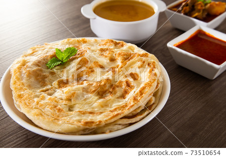 Roti Parata or Roti canai with lamb curry sauce. Roti Parata or Roti canai with lamb curry sauce. 73510654