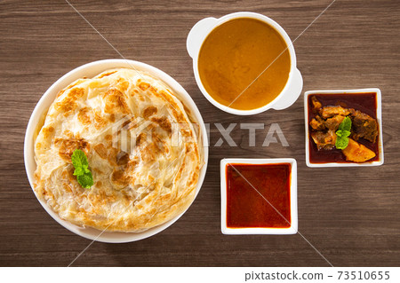 Roti Parata or Roti canai with lamb curry sauce. Roti Parata or Roti canai with lamb curry sauce. 73510655