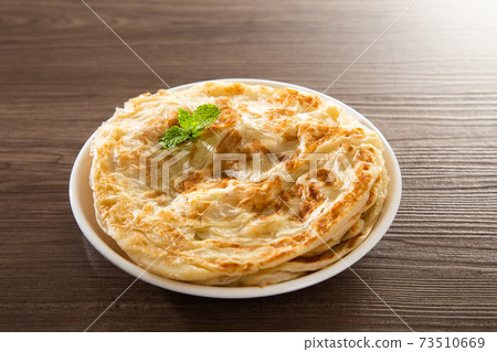 Roti Parata or Roti canai with lamb curry sauce. Roti Parata or Roti canai with lamb curry sauce. 73510669