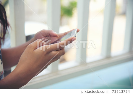 Woman hands holding mobile phone outdoor surfing internet online technology lifestyle Woman hands holding mobile phone outdoor surfing internet online technology lifestyle 73513734