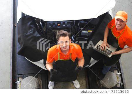 car mechanic use notebook computers to check engine and service maintenance of industrial to engine repair, for transport automobile automotive , top view image 73515655