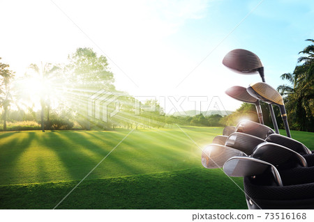 .Golf clubs drivers over beautiful golf course at the sunset, sunrise time. , morning time. .Golf clubs drivers over beautiful golf course at the sunset, sunrise time. , morning time. 73516168