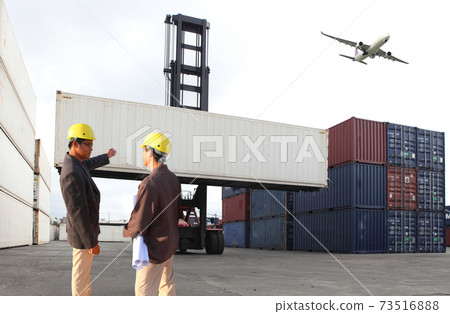 Engineering group working and they are loading container for support logistics and import export business 73516888