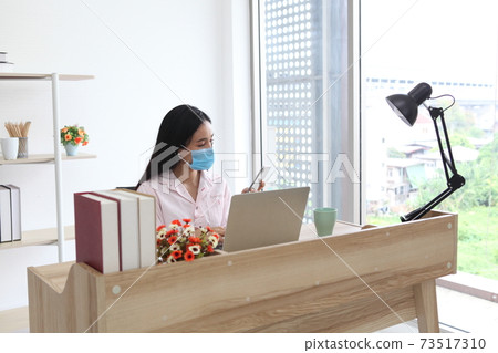 Young woman with face mask back at work in office after lockdown Young woman with face mask back at work in office after lockdown 73517310