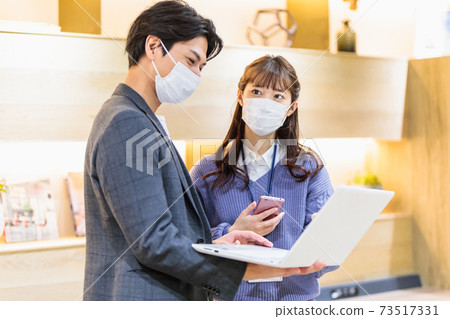 Young men and women with masks having meetings in the office Young men and women with masks having meetings in the office 73517331