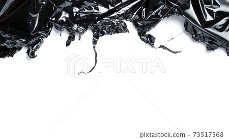 Plastic texture background. Wrap transparent dark cellophane isolated on white. Cellophane black shiny film bag pattern. Creative crumpled background. Plastic texture background. Wrap transparent dark cellophane isolated on white. Cellophane black shiny film bag pattern. Creative crumpled background. 73517568