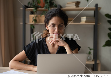 Young Caucasian woman work on laptop at home office 73517996