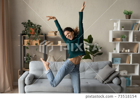 Happy millennial woman have fun dancing at home 73518154