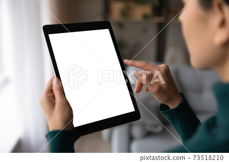 Close up woman use tablet texting online Close up woman use tablet texting online 73518210