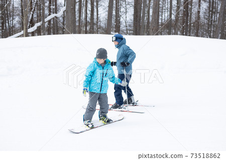 Children enjoying snowboarding Children enjoying snowboarding 73518862