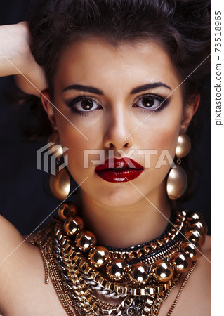 beauty rich brunette woman with a lot of jewellery, hispanic curly lady posing very emotional 73518965