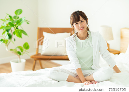 Young woman in bedroom 73519705