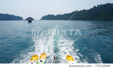 The speed boat quickly sails creating waves behind 73519940