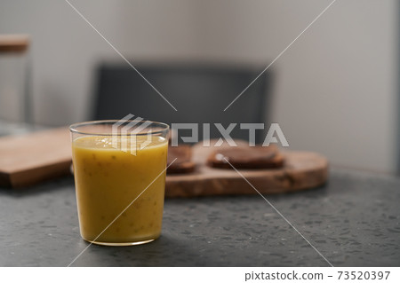 Fresh mango lulo smoothie on kitchen countertop 73520397