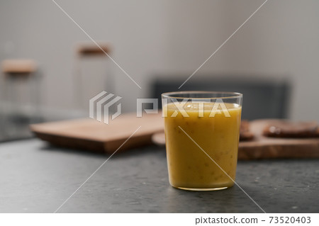 Fresh mango lulo smoothie on kitchen countertop Fresh mango lulo smoothie on kitchen countertop 73520403