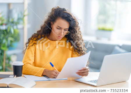 woman working on laptop at home. 73523334
