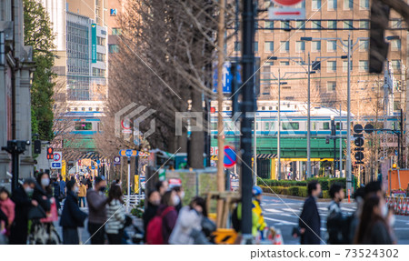 Tokyo cityscape of Japan under a state of emergency. Looking at the street corners of Marunouchi and the Shinkansen, which are crowded with people wearing masks = January 16 Tokyo cityscape of Japan under a state of emergency. Looking at the street corners of Marunouchi and the Shinkansen, which are crowded with people wearing masks = January 16 73524302