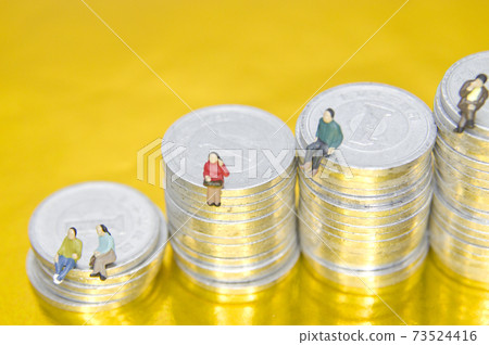 Image of money. A person is sitting on the coin stairs. 73524416