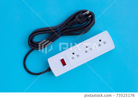 Electrical power strip and plug on blue background. Top view 73525176