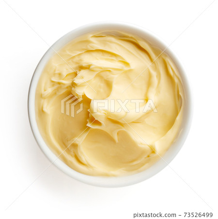 Bowl of butter on white background 73526499