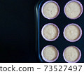Baking banana cake. Homemade healthy banana cake made with oat flour in cup prepare for bake on black background. 73527497