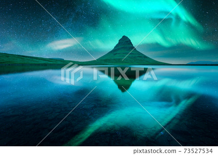 Aurora borealis Northern lights over Kirkjufell mountain Aurora borealis Northern lights over Kirkjufell mountain 73527534