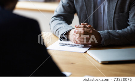 Close up focus on clasped hands of male entrepreneur. 73528076