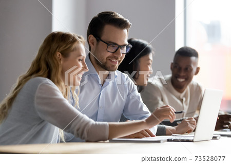 Happy young female employee discussing online project with boss. 73528077