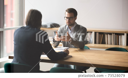 Two successful male partners negotiation project ideas in boardroom. 73528079