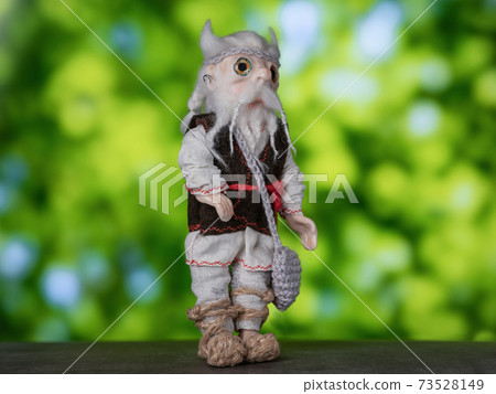 Leshy in traditional Russian clothes, with a bag in which there is bread. Leshy in traditional Russian clothes, with a bag in which there is bread. 73528149