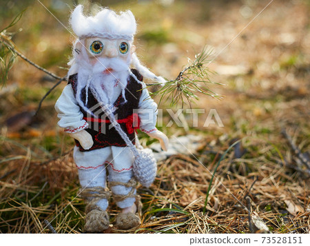 Leshy in traditional Russian clothes, with a bag in which there is bread. Leshy in traditional Russian clothes, with a bag in which there is bread. 73528151