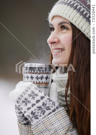 Happy Woman Drinking Hot Cocoa in Winter Park Happy Woman Drinking Hot Cocoa in Winter Park 73528441