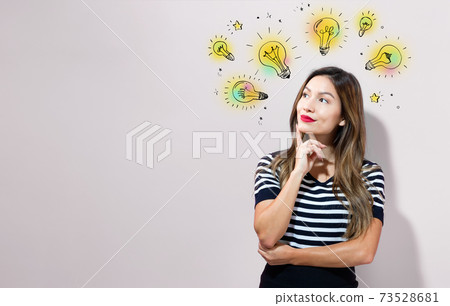 Idea light bulbs with young businesswoman 73528681