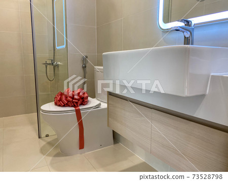 Brand new toilet and sink inside modern restroom 73528798