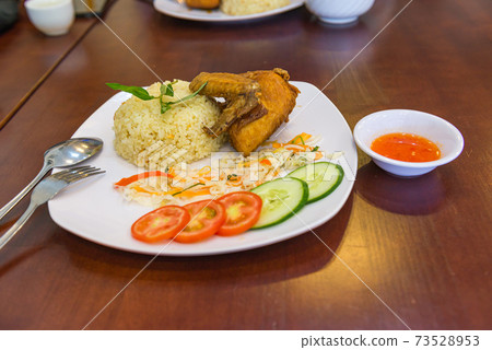 Plate of tasty deep-fried chicken wing and rice in restaurant Plate of tasty deep-fried chicken wing and rice in restaurant 73528953