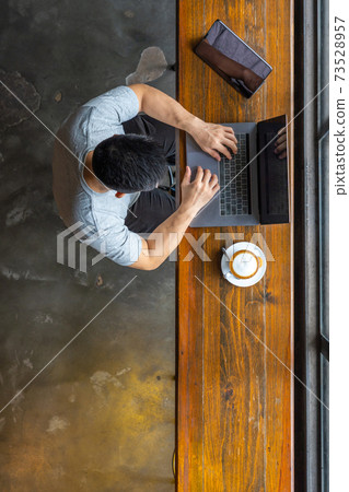 Vertical high angle view photo of businessman typing laptop 73528957