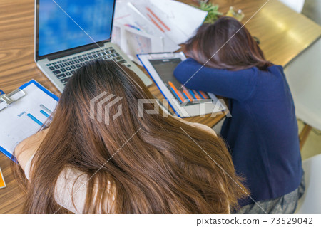 Young businesswoman frustrated and sleeping on desk Young businesswoman frustrated and sleeping on desk 73529042