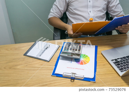 Businessman hands holding report at workplace 73529076