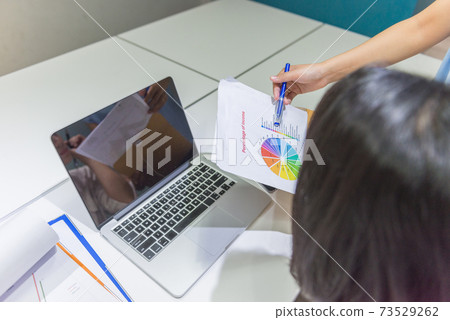 Business people discuss about financial number on document 73529262