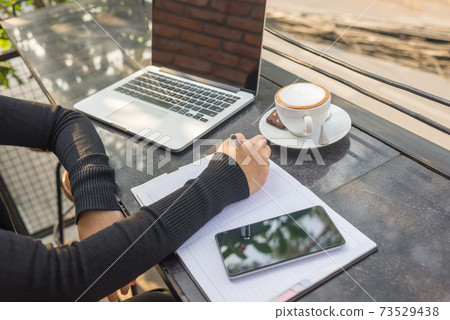 Woman hand writing notes outdoor Woman hand writing notes outdoor 73529438