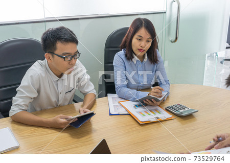Sales team analyze sales reports in meeting room Sales team analyze sales reports in meeting room 73529764