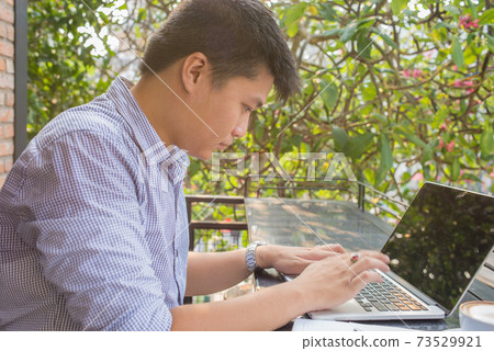 Young freelancer working on laptop Young freelancer working on laptop 73529921