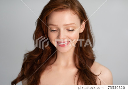 Beauty Portrait Of Red-Haired Young Lady Over Gray Studio Background Beauty Portrait Of Red-Haired Young Lady Over Gray Studio Background 73530820