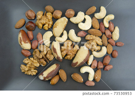 different nuts on a plate 73530953