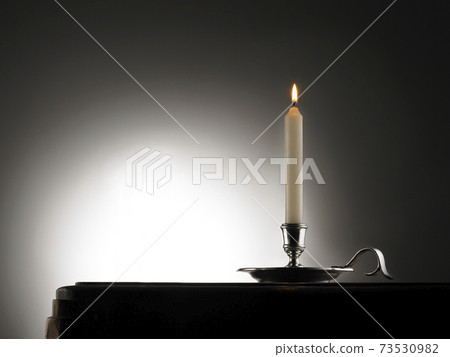 Lighting candle on wood table Lighting candle on wood table 73530982