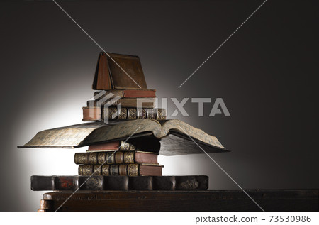 Ancient books on a table Ancient books on a table 73530986