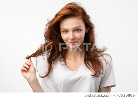 Girl Posing Touching Healthy Red Hair Posing Over White Background Girl Posing Touching Healthy Red Hair Posing Over White Background 73530999