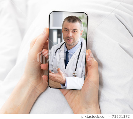 Professional Male Therapist Consulting Online Through Video Conference On Smartphone 73531372